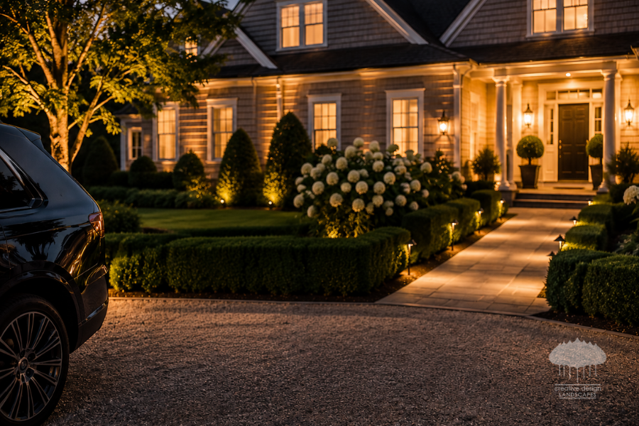 Landscape crew completing a guest-ready Hamptons landscaping walk-through at dusk